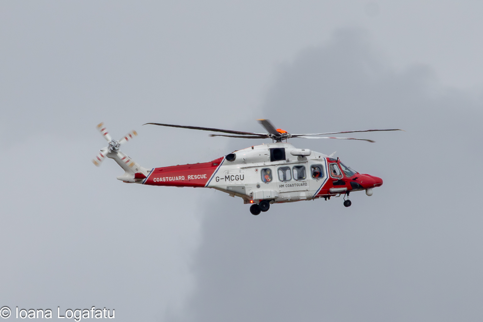 Helicopter navigating through cloudy skies above